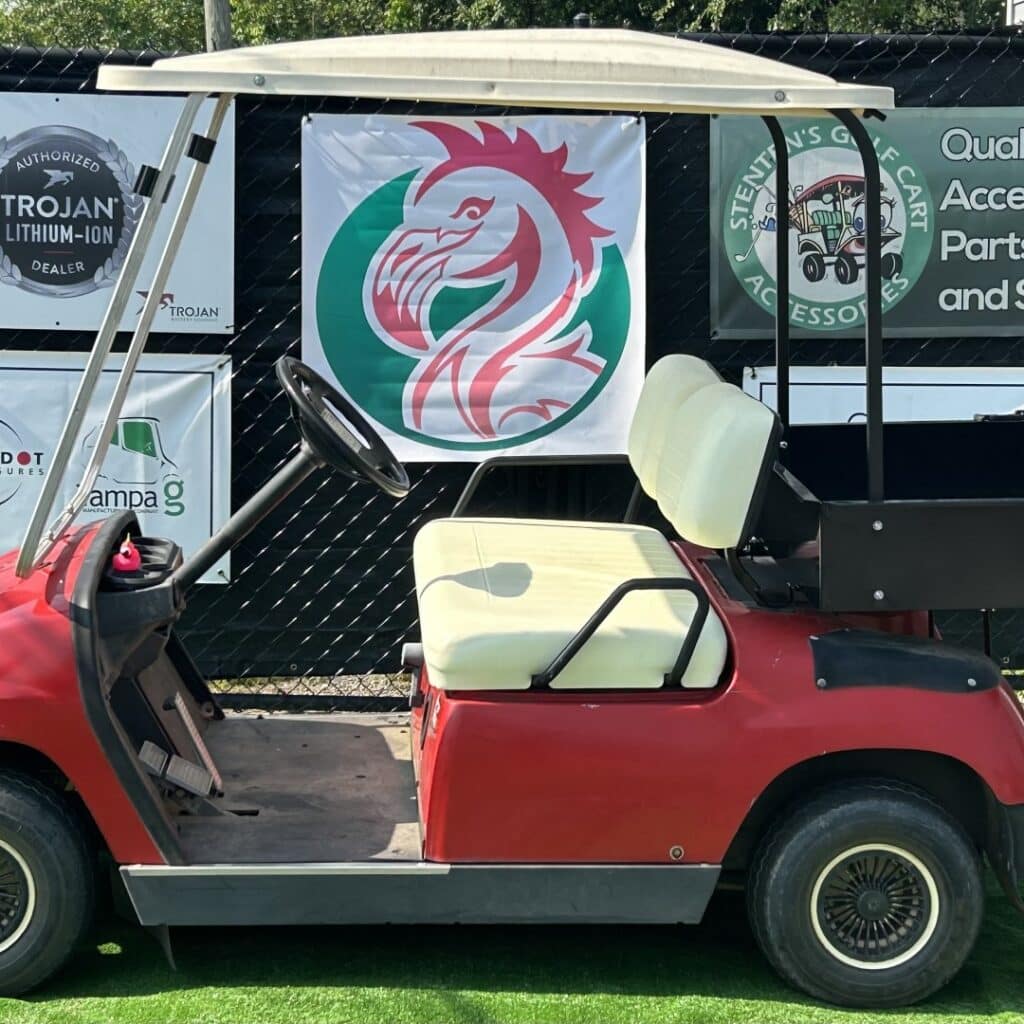 Used Yamaha golf cart with Trojan Batteries logo and accessories displayed.