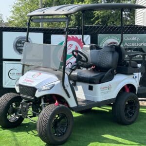 Customized white 4-passenger golf cart with aftermarket wheels and accessories.